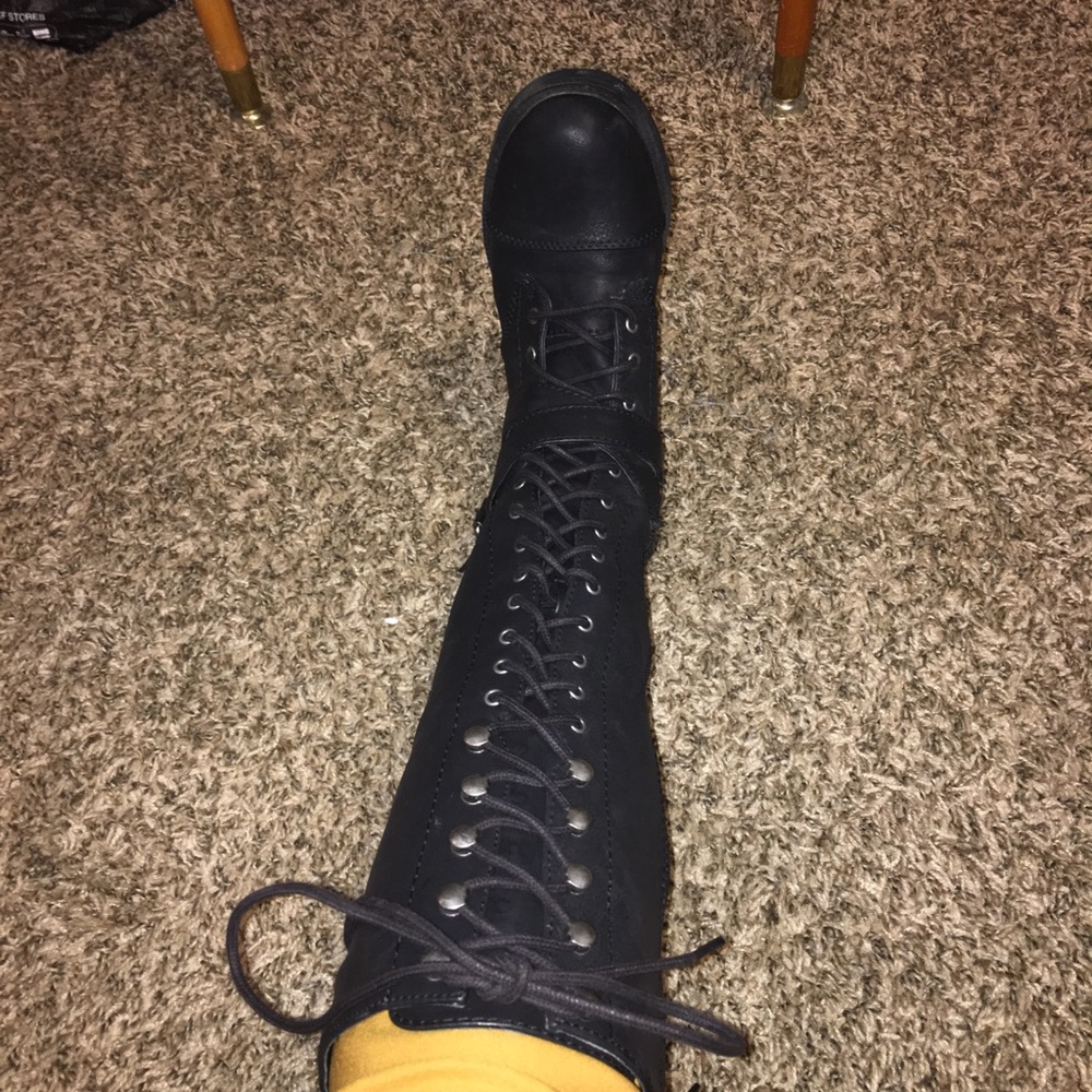 Knee-length lace up tall black boots